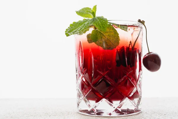 Cherry Juice in a Glass With Mint and Fresh Cherries Close Up on White Background, Copy Space
