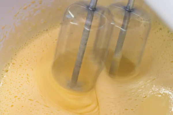 Mixing biscuit dough with an electric mixer. close up process. Cake batter making.