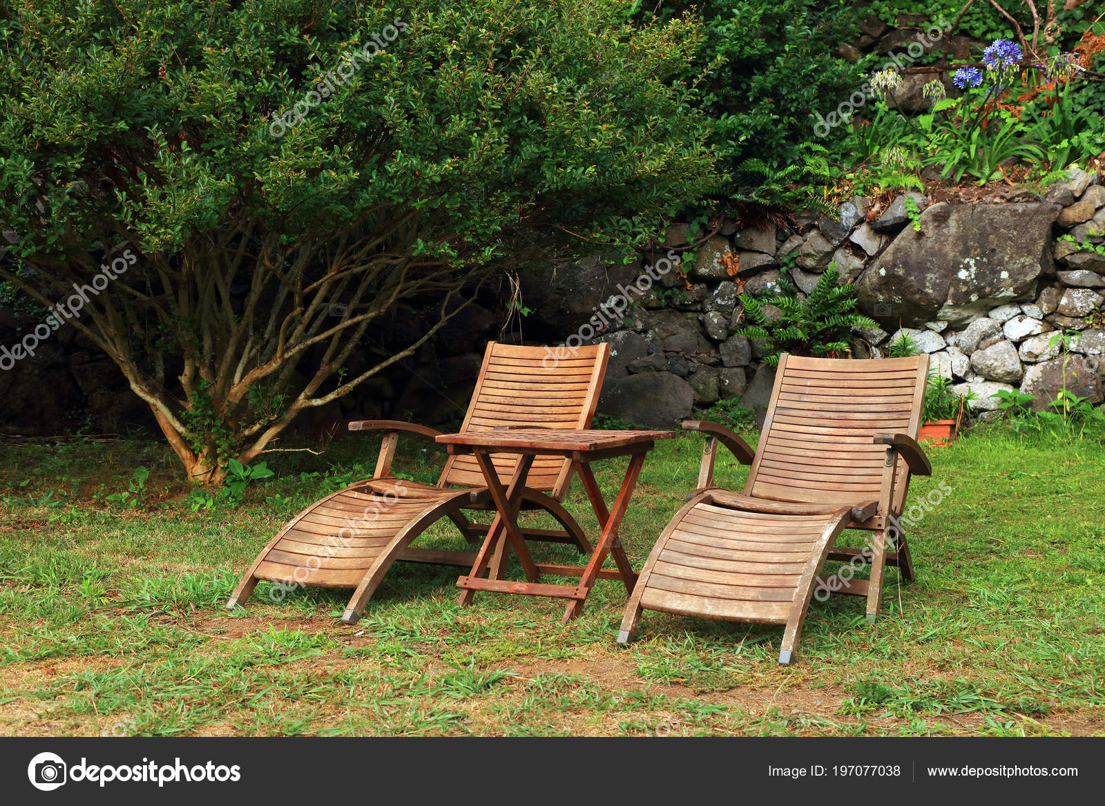 wooden sun loungers in the garden 197077038