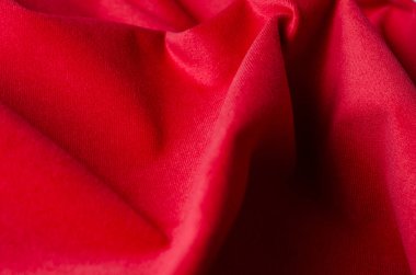 Parlak kırmızı velour tekstil örneği. Kumaş doku arka planı