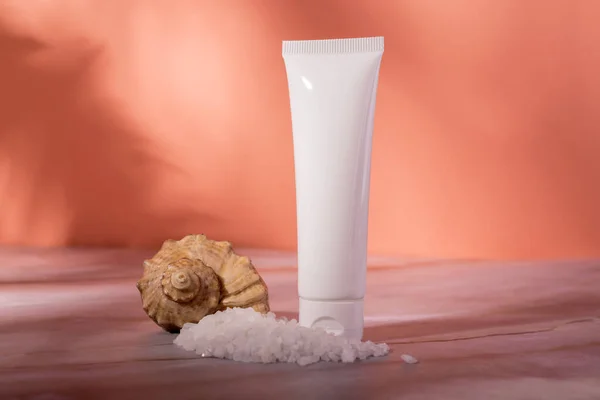 Sea Salt Skin Care Cosmetics bottle on a marble background. Dead sea natural cream package mockup.