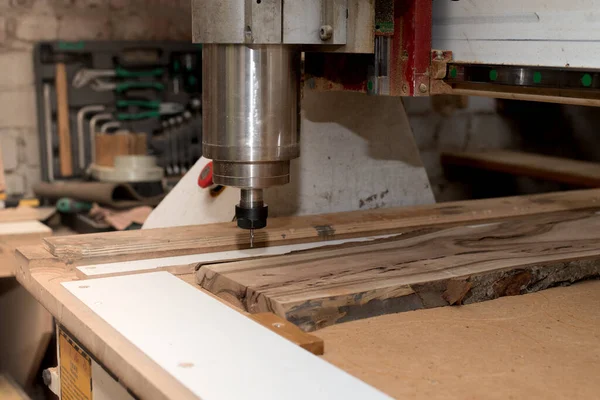 Woodwork cnc machine working on wood board. Machine tool at the wood factory.