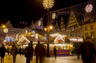 Wroclaw, Polonya - 25.11.2019: Geleneksel Noel Piramidi Rynek Meydanı 'nda tarihi belediye binasına karşı. Uzun süreli maruz kalma.