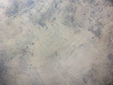 Concrete beige gray background with scuffs and gray splashes. Textured wall texture in the grunge style.