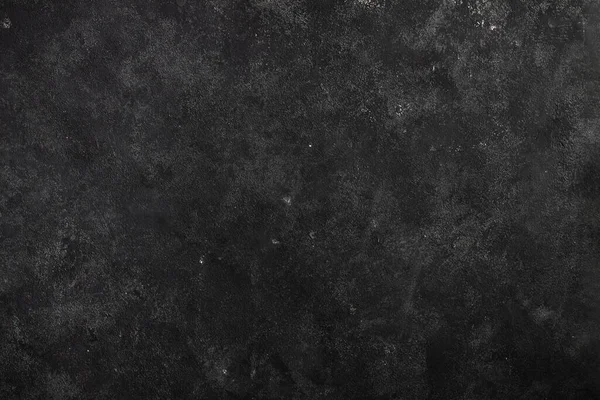 Çimento koyu gri arka plan, sürtünmeler ve siyah lekeler. Grunge biçiminde desenli duvar dokusu.