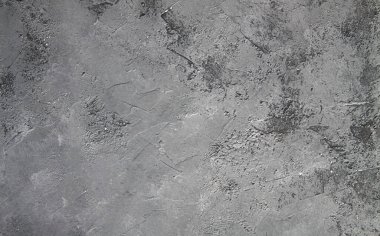 Retro taş beton, koyu gri arka plan, eski sürtünmeler ve siyah lekeler. İğrenç boyanmış döşeme ya da grunge tarzında duvar çimento dokusu. Metin için boşluk