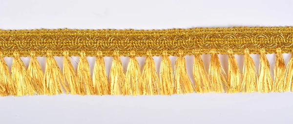 Braid lace made Luxury Metallic golden cord on white background. decoration for carnival and dance clothes costumes. Christmas texture. banner for website