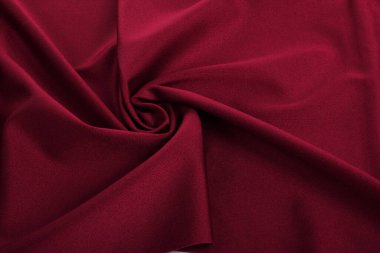 Kırmızı örülmüş elastik kumaş, ipliklerin dokuması, kıvrımlı kıvrım. İç çamaşırı, spor kıyafetler ve mayo için. Metin için boşluk.