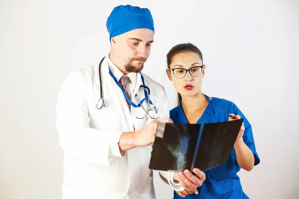 Los médicos miran la radiografía, ven el problema y lo discuten. Fondo blanco — Foto de Stock