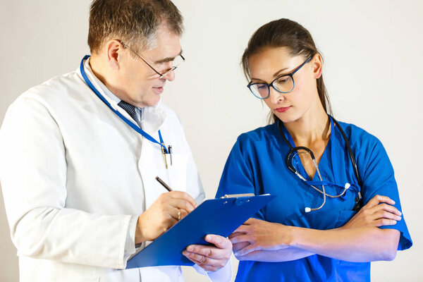 Senior physician tests the knowledge of the young doctor.