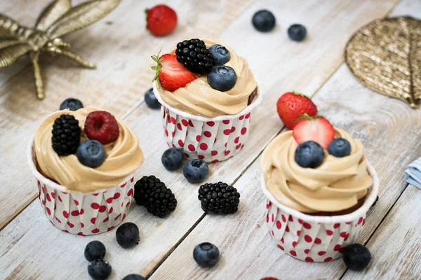 Perfect cupcakes with cream and berries for breakfast