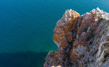kayalık dağlar ve Baykal Gölü'nün berrak suyu