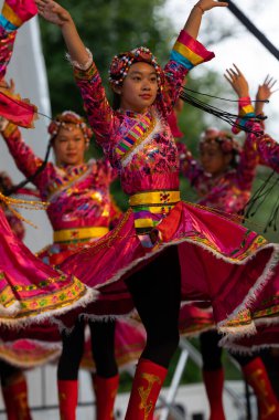 St. Louis, Missouri, USA - August 25, 2019: Festival of Nations, Tower Grove Park, Members of the St. Louis Modern Chinese School, wearing traditional clothing, performing traditional dances from China clipart