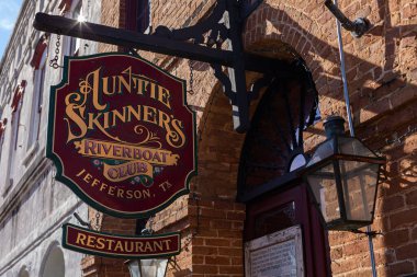 Jefferson, Texas, USA - November 16, 2019: The sign of the Auntie Skinner's Riverboat Club clipart