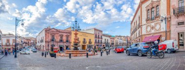 Zacatecas, Zacatecas, Mexico - November 22, 2019: The Fuente de los Faroles, busy street intersection, with locals and tourists exploring the shops and restaurants clipart
