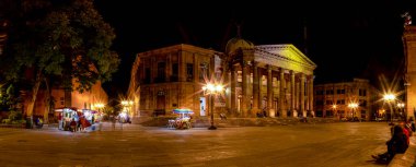 San Luis Potosi, San Luis Posoti, Mexico - November 22, 2019: The Theatre of Peace, with street vendors, and people enjoying the night clipart