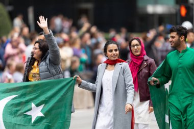 Houston, Texas, USA - November 28, 2019: H-E-B Thanksgiving Day Parade, Members of the Pakistani community in Houston walking down Milam street during the parade clipart