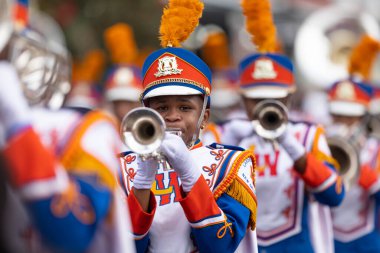 New Orleans, Louisiana, USA - November 30, 2019: Bayou Classic Parade, Members of the Andry-Walker High School Marching Band performing at the parade clipart
