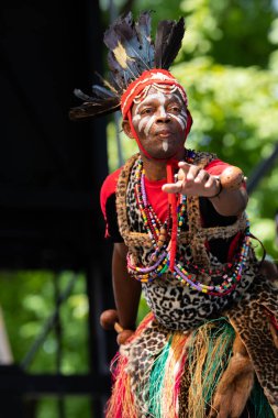 St. Louis, Missouri, USA - August 24, 2019: Festival of Nations, Tower Grove Park, Members of the Drums and Dance of the Congo, wearing traditional clothing, performing traditional songs and dances from Congo clipart