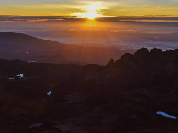 Sunrise above the clouds at Point Lenana, Mount Kenya