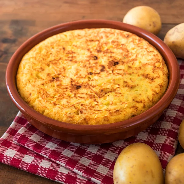Traditional spanish tortilla on rustic wooden texture