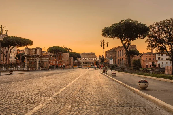 way to colosseum in rome at sunset