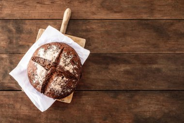 Ahşap masa taze ekmek. Üstten görünüm kopya alanı ile. Çavdar ekmeği kesme kurulu closeu Tarih