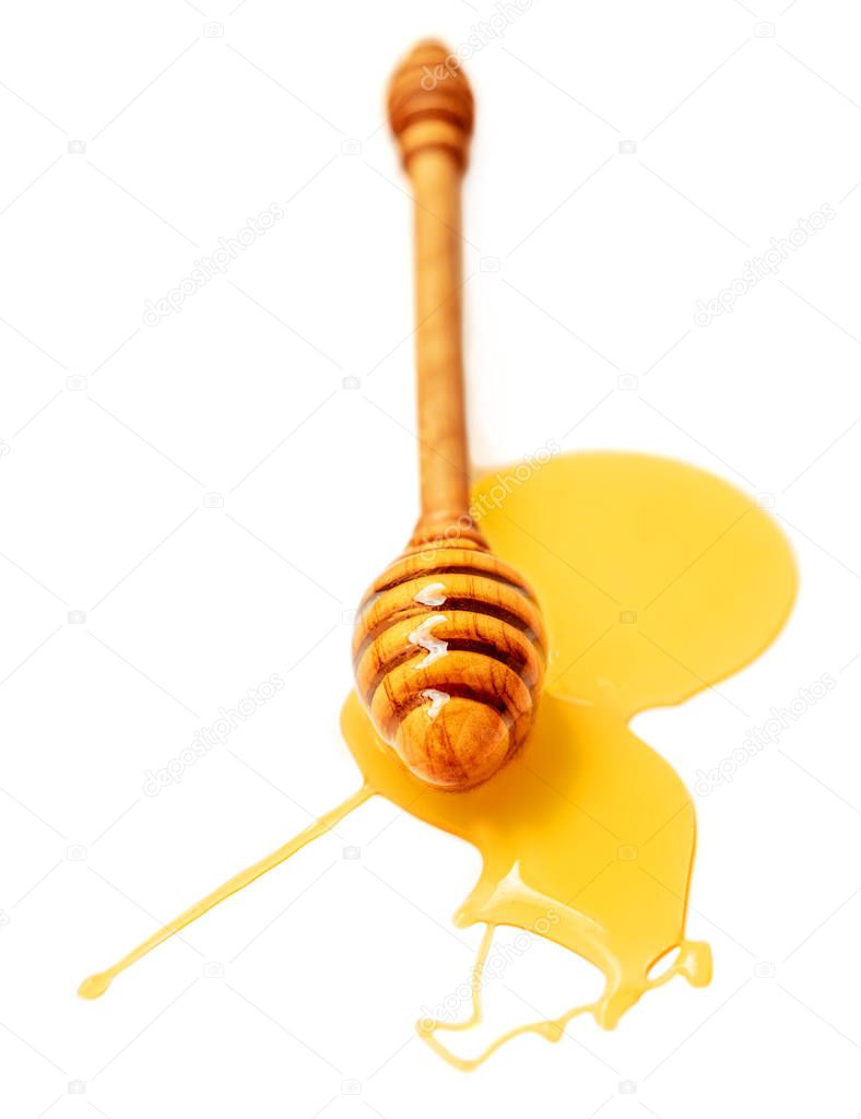 Honey dripping isolated on a white background. Honey flowing drops, close up