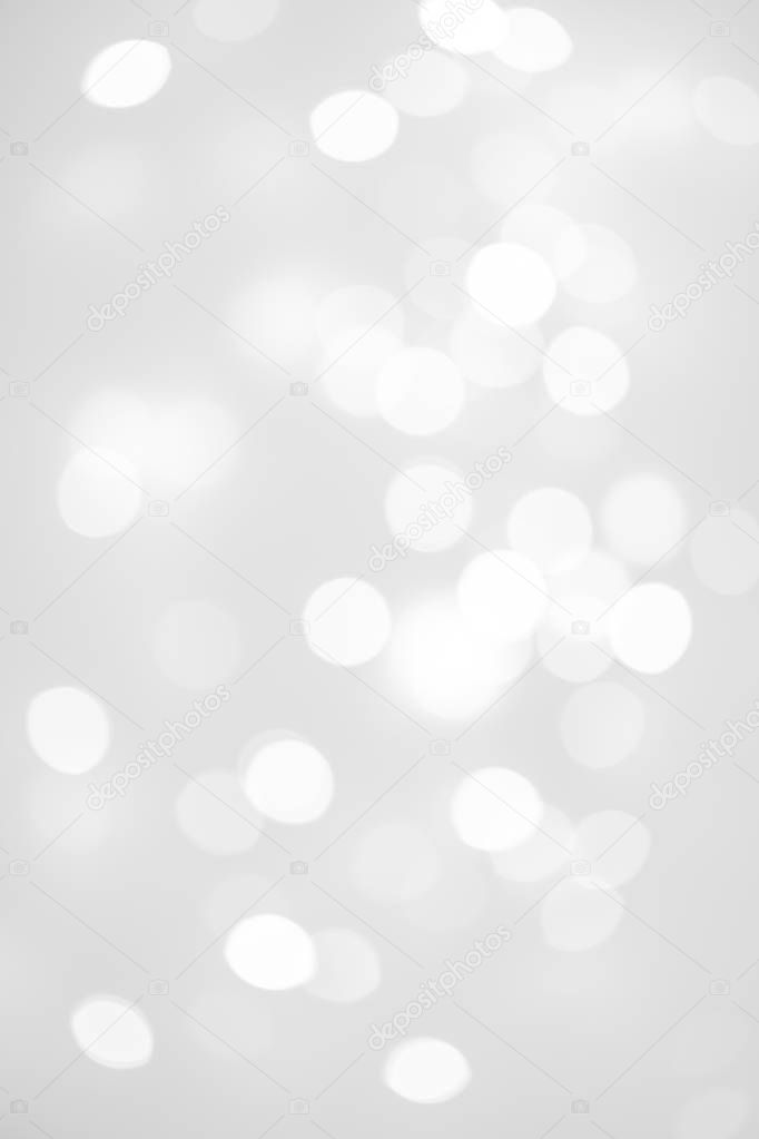 Elegant Abstract Silver Christmas Background with white bokeh lights for Holiday Poster, Banner, Ad, Card or invitation