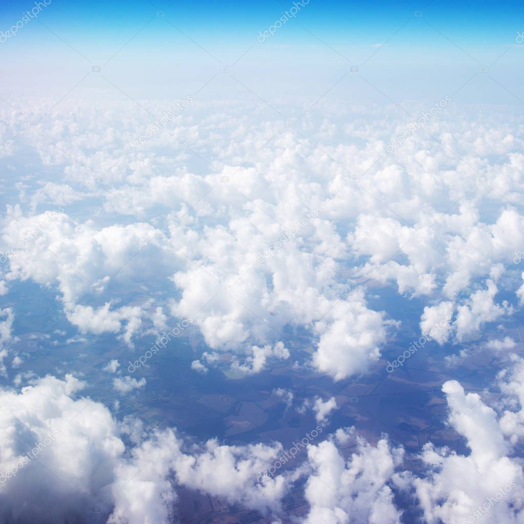 Beautiful Sky above the clouds. View from the airplane window with blue sky and fluffy clouds