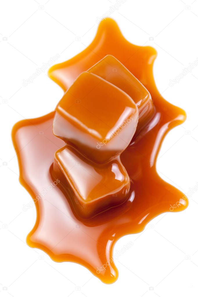 Sweet Caramel candies with caramel topping  sauce isolated on a white background close up.