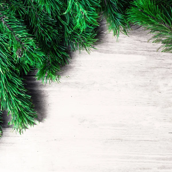 Christmas frame with fir tree  branches on  white  wooden background. Christmas wallpaper. Flat lay, top view. Copy space