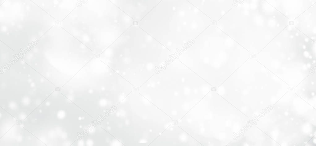 Silver abstract bokeh background with snowflake and white glittering bokeh stars. A shiny holiday card. Glowing blurred light