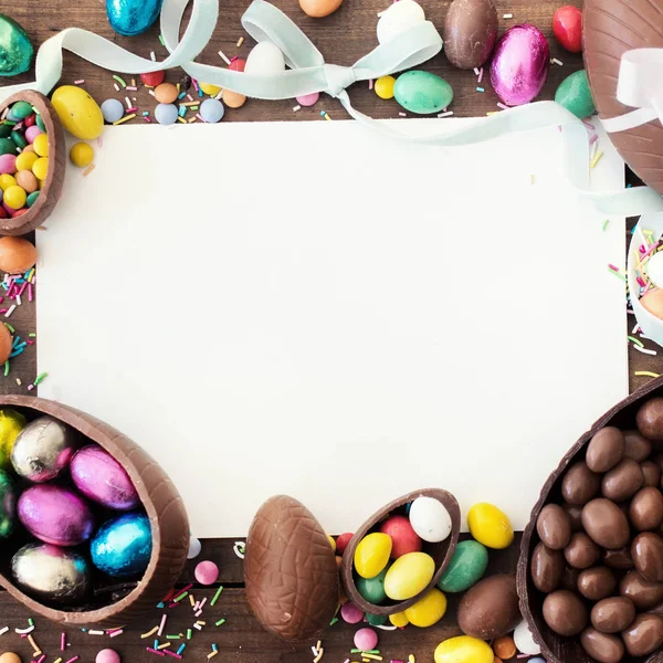 Happy Easter frame with blank space for text,  chocolate eggs,  ribbon bows and candies. Easter concept