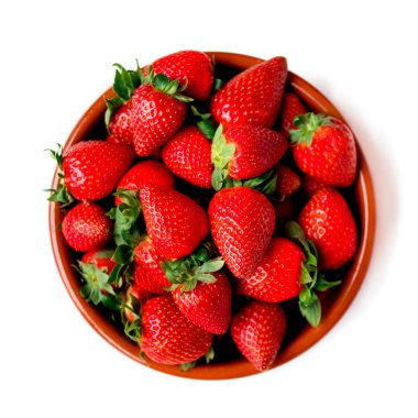 Heap of fresh strawberries in ceramic bowl isolated on  white background. Top view clipart