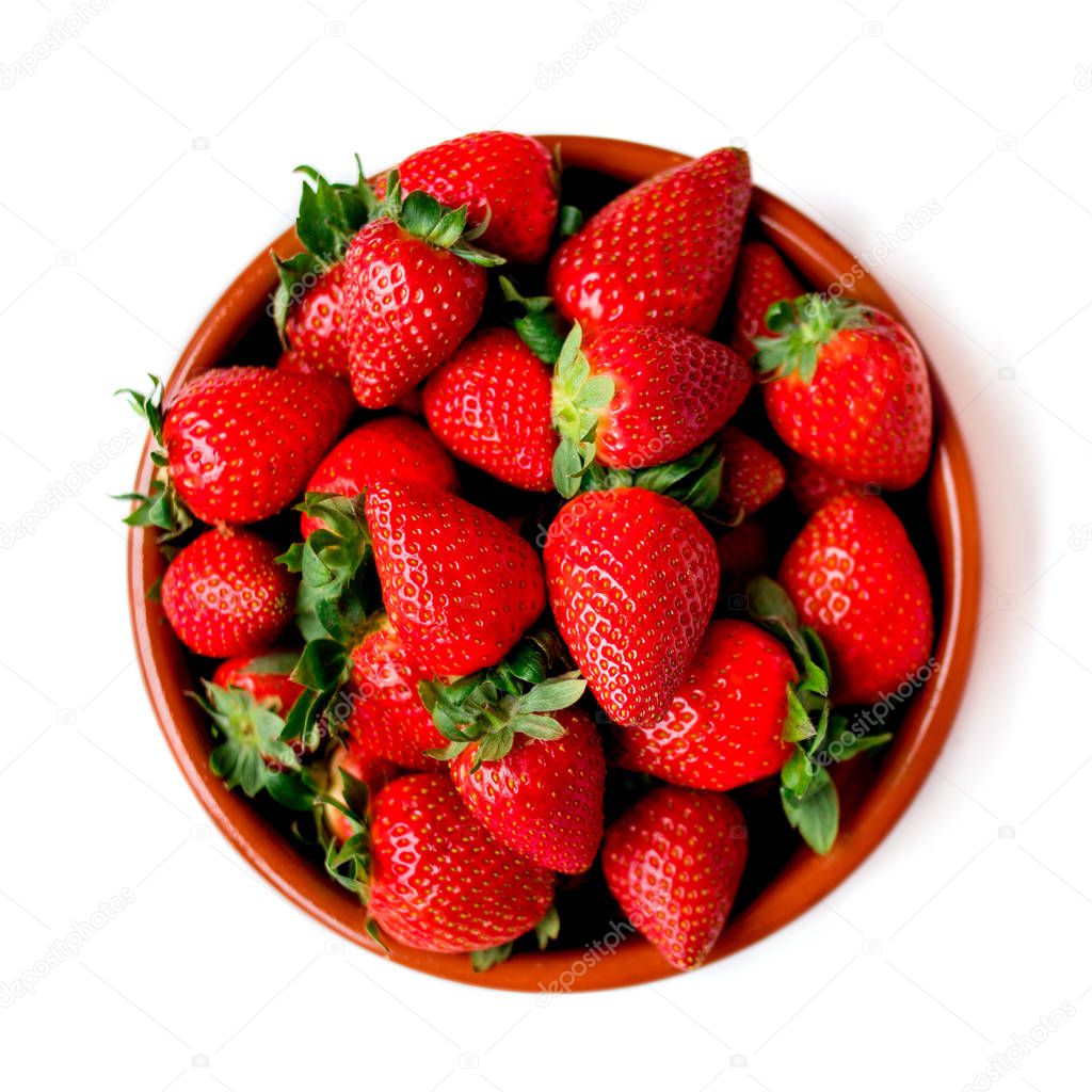 Heap of fresh strawberries in ceramic bowl isolated on  white background. Top view