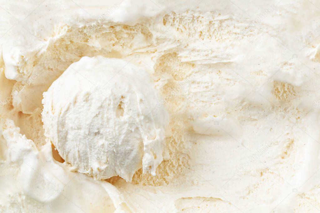 Vanilla ice cream with a scoop in  container as background. Macr