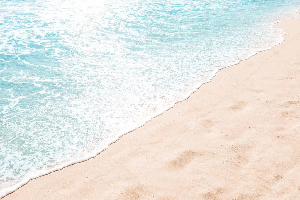 Blue ocean wave on sandy beach. Summer day and sand beach background concept.