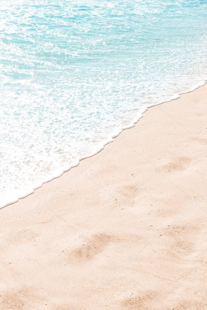 Blue ocean wave on sandy beach. Summer day and sand beach background concept.