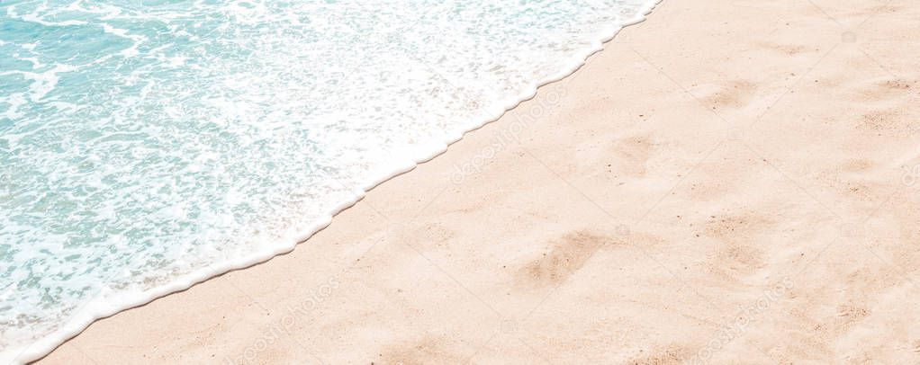 Blue ocean wave on sandy beach. Summer day and sand beach background concept.