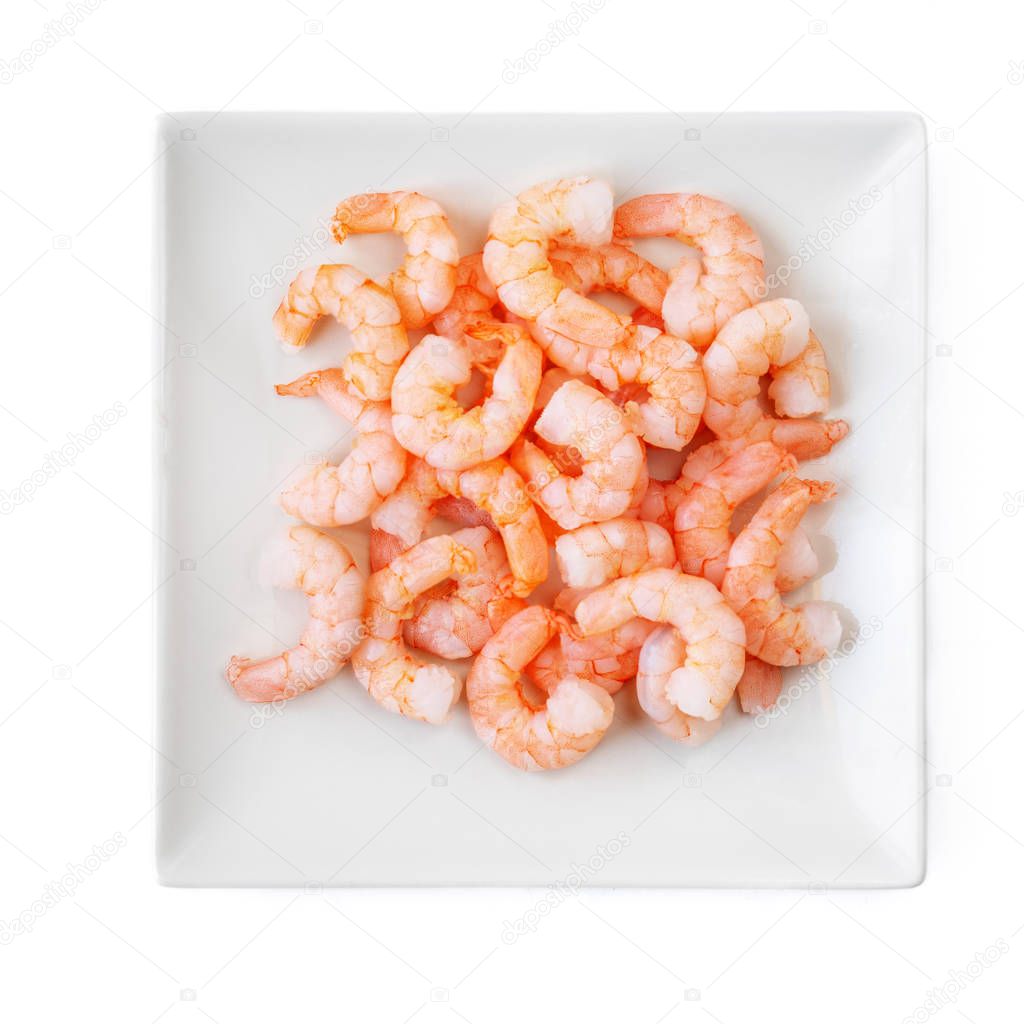 Peeled shrimps on a plate isolated on white background. Top view