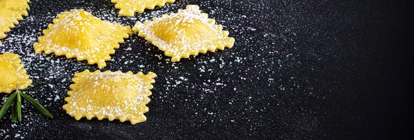 Raviolli with flour and herbs on dark background, top view.  Cop — Stock Photo, Image
