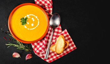 Koyu arka planda kabak çorbası. Lezzetli kabak krema kase çok