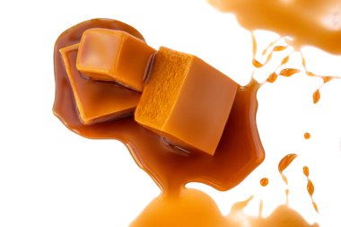 Beyaz arka planda izole edilmiş karamel ve karamel sosu. Şekerleme.