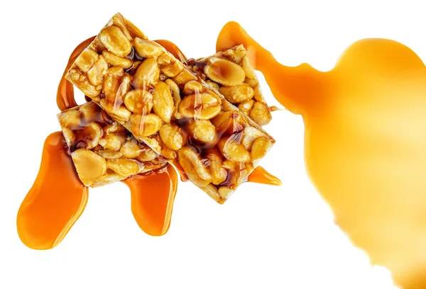 Nut bar with peanuts  and melted caramel  isolated on white background. Muesli energy  cereal  bar top view