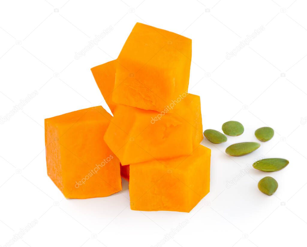 Pumpkin pieces with  seeds  isolated on white background. Diced Pumpkin, close up