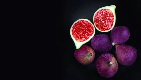 Fresh ripe figs on dark Background. Beautiful blue violet figs with empty copyspace close up. Food phot