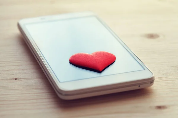 smartphone with red heart on screen, social media, online dating concept, like and thumb for posts, instagram, feedback
