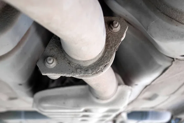 Dust part of the exhaust pipe at the bottom of the car, mounted on two bolts — Stock Photo, Image