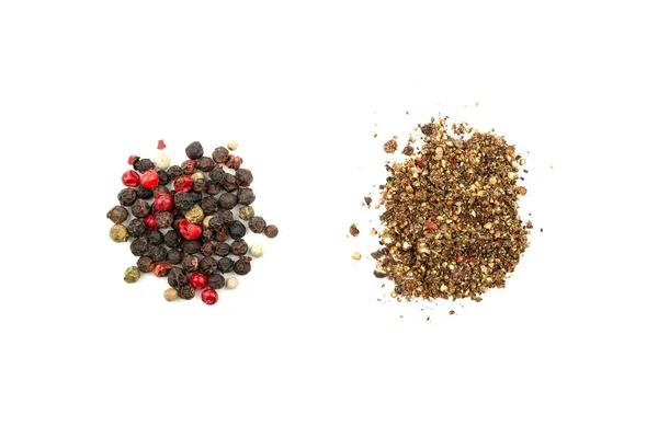Two piles of pepper mix: grain and ground. A mix of four types of pepper grain: black, white, pink, green. Closeup top view. Isolated on white background — Stock Photo, Image